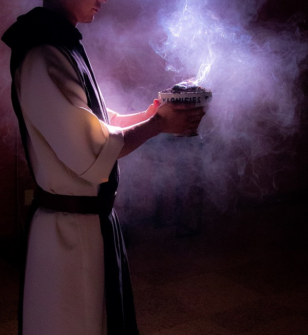 Monk carrying a bowl of holy incense